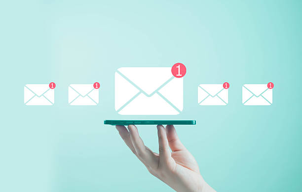 istock Hand holding smartphone with new email message icons and notification alerts on turquoise background, representing communication, email marketing, online messaging, digital connection, and business 2244802826