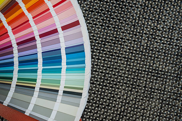 istock Multicolored paint swatches arranged on black woven surface for color selection concepts 2244802874
