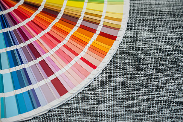 istock Multicolored paint swatches arranged on black woven surface for color selection concepts 2244803484
