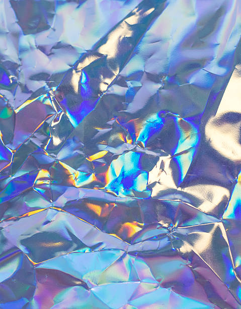 istock Iridescent crumpled foil texture with rainbow reflections for abstract, futuristic design 2244805386