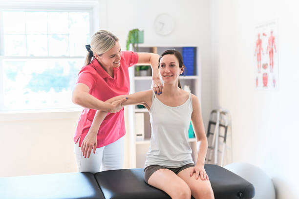 istock Modern rehabilitation physiotherapy clinic with professional and client 2244806312