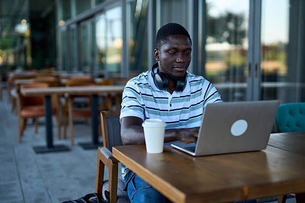 istock One black man working on laptop outdoor at cafe 2244807967