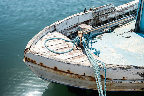 A lila boat on the sand close to an orange buoy. Cantabrian coast, Spain