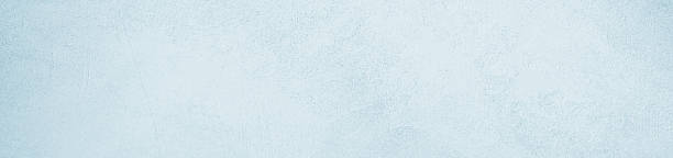 istock Light blue mint white concrete cement wall grungy surface texture background. Pale soft pastel shade. Painted plaster. Simple minimal. Blank empty template design. Christmas winter cold. Wide banner. Panoramic. 2244808999