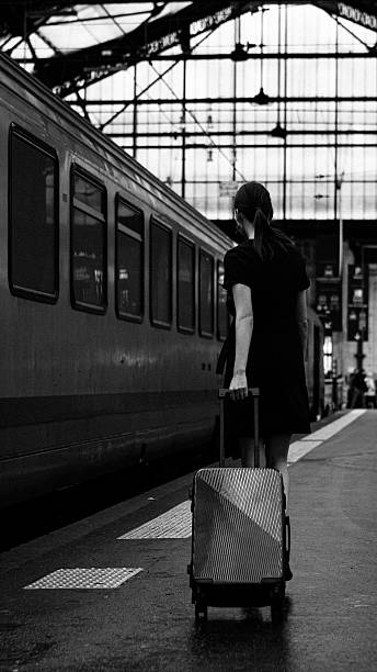 istock A woman with luggage on a train platform. 2244811341