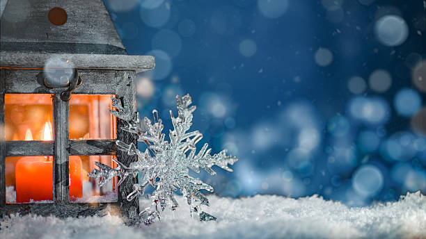 istock Lantern with Candle and Glitter Snowflake in Winter Night 2244813781