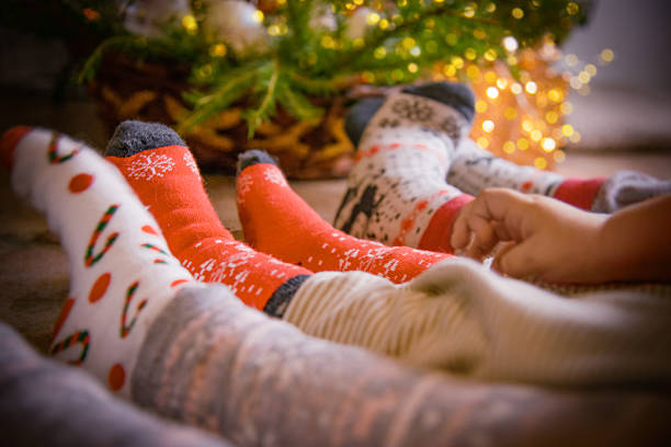 istock Cozy Family Christmas Socks by the Tree 2244813922