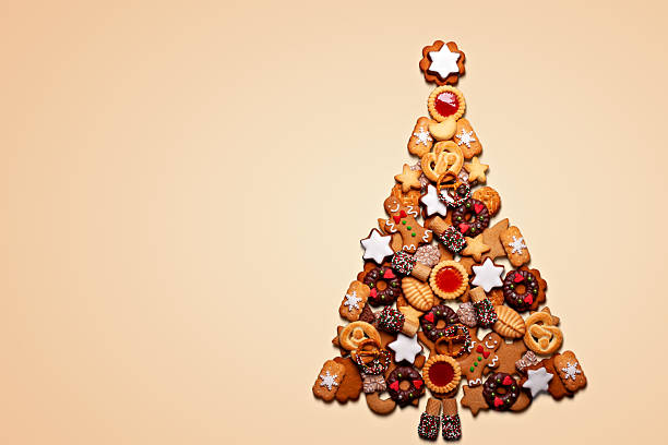istock Christmas tree made from Assorted Christmas Gingerbread cookies on light background with copy space 2244813939
