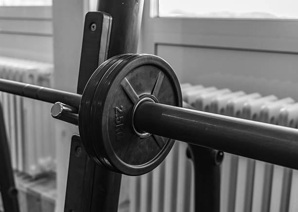 barbell and barbell discs in an athletic gym