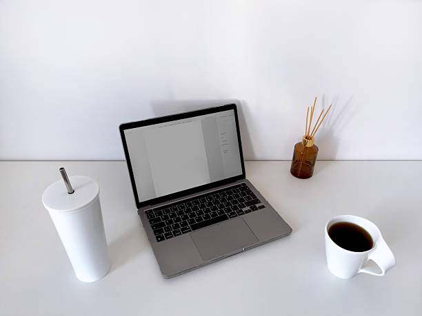 istock Minimalist workspace with laptop screen coffee and tumbler cup 2244815573