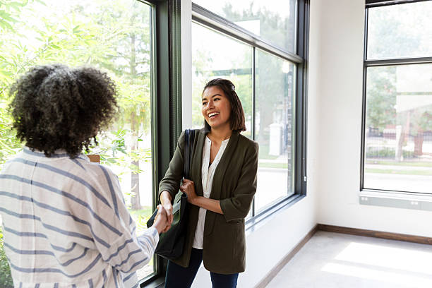istock Two professional women shake hands and smile, sharing a positive business connection. 2244815938