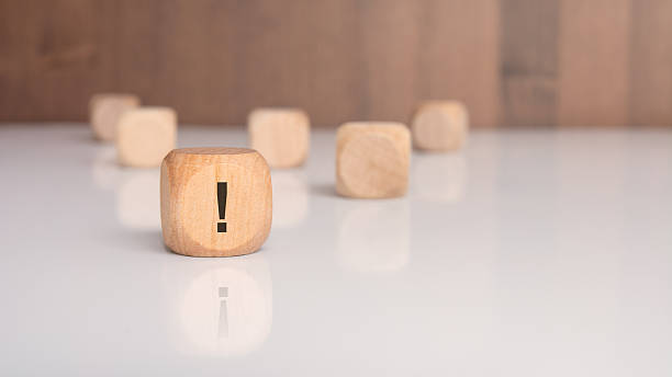 istock wooden block with exclamation mark symbol on white glossy table 2244817744