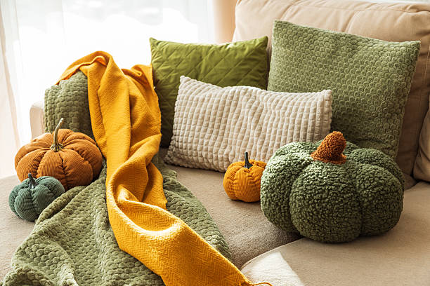 istock Autumn Sofa Styling with Textured Pillows, Fabric Pumpkins, and Cozy Blankets 2244819566