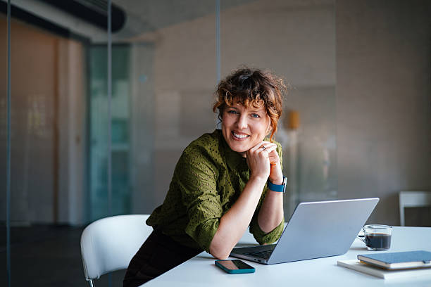 istock Professional Woman Smiling At Laptop During Work Break In Modern Office Coworking Space 2244825165