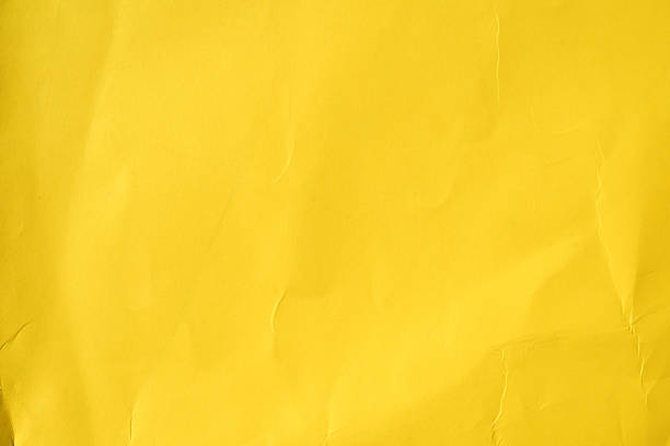 istock Yellow crumpled paper background with texture and creases 2244825814