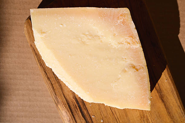 istock Parmesan cheese block on a wooden cutting board 2244826458
