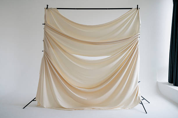 istock A beige silk backdrop on a stand in a photo studio 2244828389