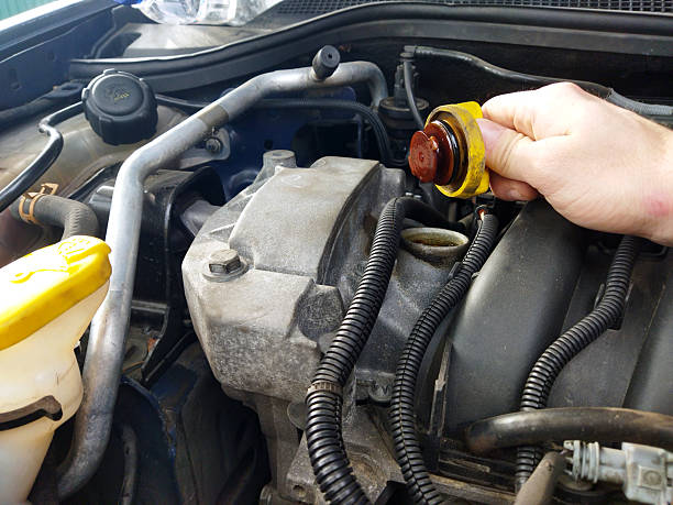 istock Checking the oil level in a car engine at the garage 2244834909