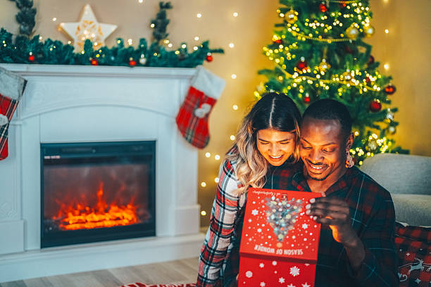 istock Romantic couple enjoying Christmas by the fireplace. 2244835563