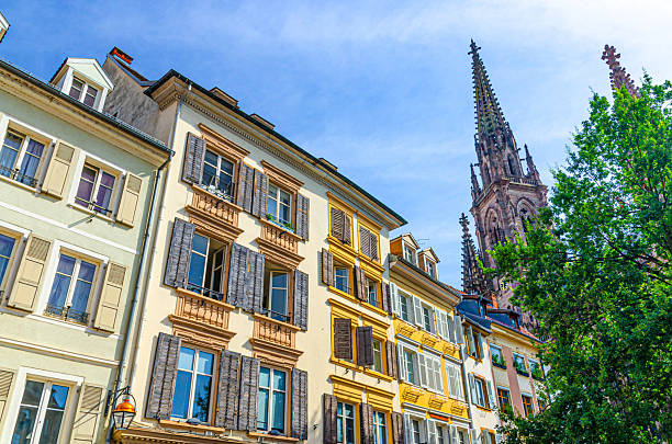 istock Old colorful buildings walls with shutter windows, typical multicolored houses and Temple Saint-Etienne church Mulhouse Cathedral bell tower in old town Mulhouse city historic centre, Alsace, France 2244838088