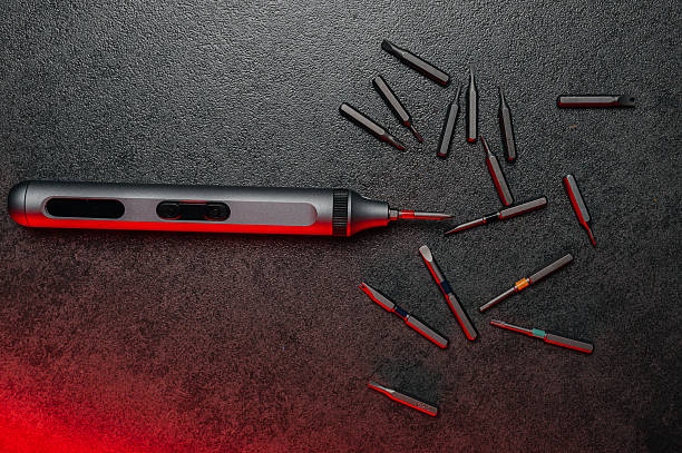 istock Electric rechargeable cordless mini screwdriver and set of different interchangeable bits in plastic case on a gray background 2244838374