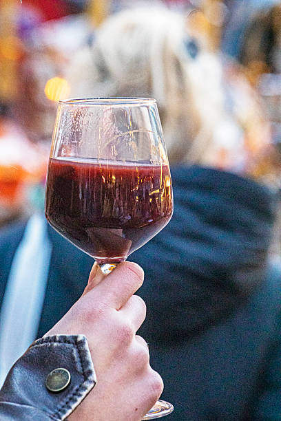 istock Drinking hot punch from a glass at a street fair. 2244838411