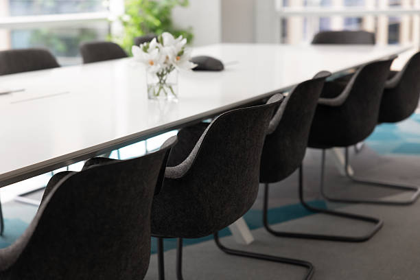 istock Large white meeting table and grey empty chairs in office 2244842906