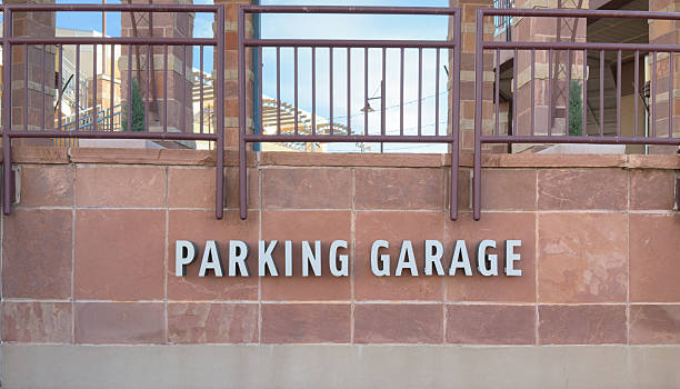 istock Parking Garage sign on stone wall with railing 2244843491