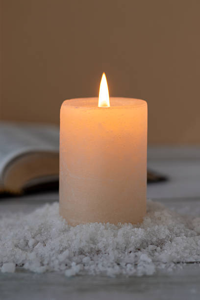 istock Salt and candle with holy bible book in the background 2244844270