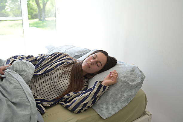 young woman sleeping in her bedroom