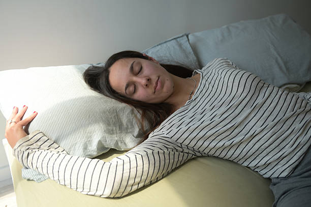 young woman sleeping in her bedroom