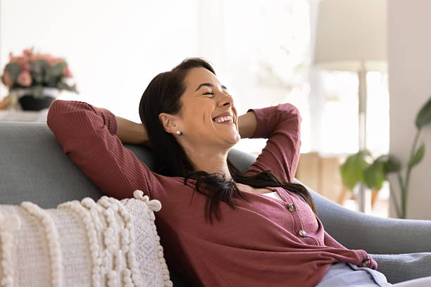 istock Cheerful relaxed young Hispanic homeowner woman resting on comfortable sofa 2244849140