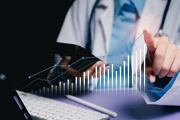 istock Healthcare professional analyzing data with graph on digital screen and laptop in modern office environment 2244850086