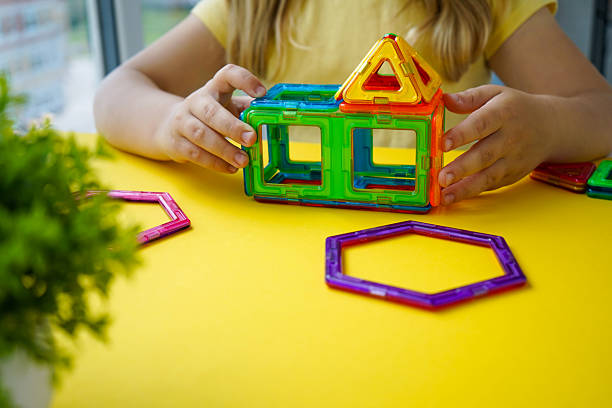 istock A young mind explores geometry through play, connecting colorful magnetic shapes to create balanced three-dimensional constructions. 2244850511