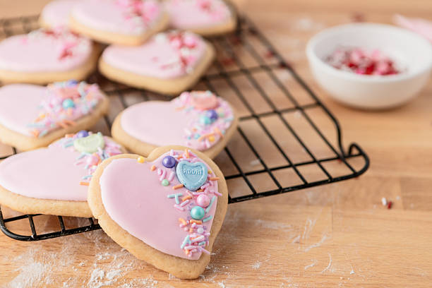 istock Heart-Shaped Sugar Cookies on a Cooling Rack with Sprinkles 2244851256