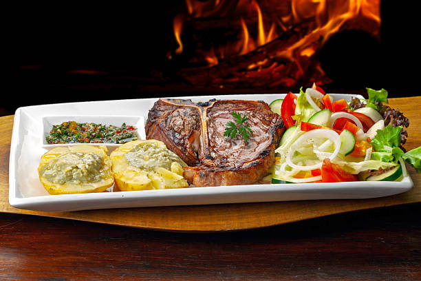 t bone steak with potatoes and salad