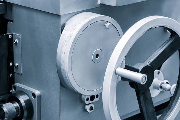 istock lathe machine with  white handle and silver wheel.  handle is attached to machine that is used to cut metal 2244852216