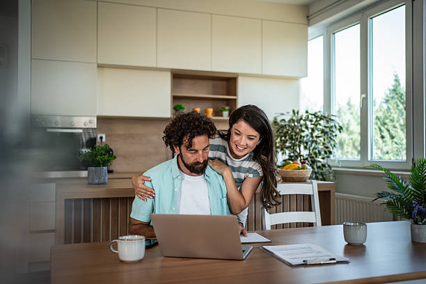 istock Couple managing home finances viewing laptop together 2244852371