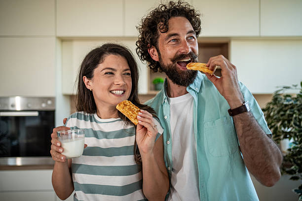 istock Happy couple enjoying waffle breakfast in modern kitchen 2244854354
