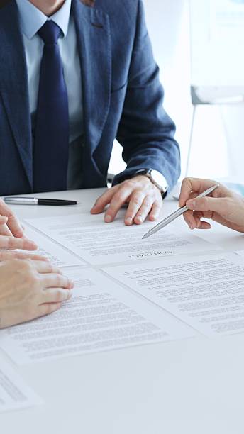 istock Business colleagues reviewing contract documents during an office meeting, discussing terms, and preparing for agreement signing, focusing on legal consultation and partnership discussion 2244857569