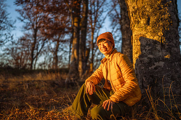 istock Woman smiling relaxing a golden hour forest 2244857599