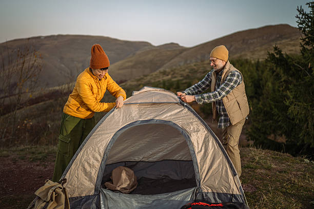 istock Couple preparing camping tent in mountain nature 2244857966