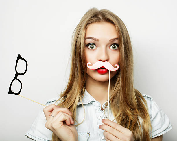 istock Party image.Young woman holding a party glasses. 2244858559