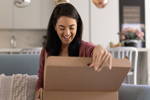 istock Happy excited Hispanic customer woman opening logistic cardboard box 2244859551
