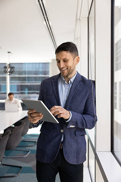 istock Happy successful young businessman using modern technology for online communication 2244860261