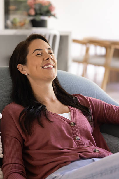 istock Positive serene young Latin woman relaxing on soft couch 2244861624