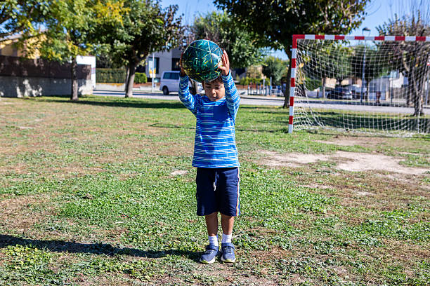 Photo portrait of cute preteen schoolboy play football winning home education concept school interior.