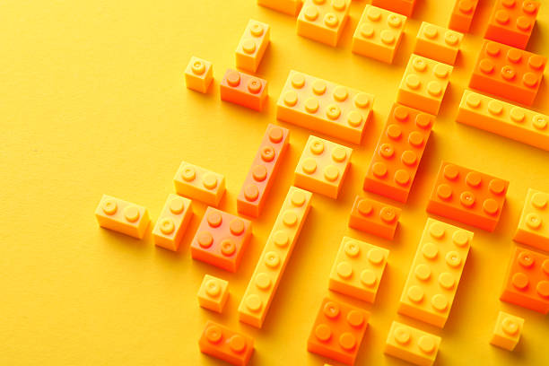 Constructor toy. Many building blocks on yellow background, above view