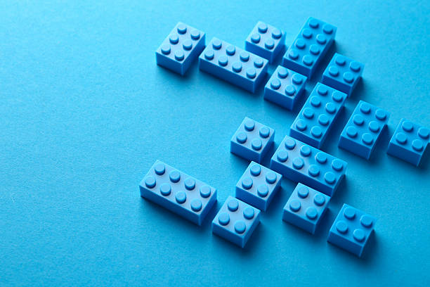 Constructor toy. Many building blocks on light blue background, above view