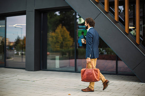 istock Young businessman walking carrying bag and coffee 2244864848